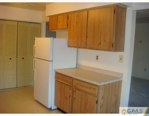 1630 Raspberry Court Edison, NJ 08817 - Photo 4 of 8 a kitchen with a refrigerator and cabinets