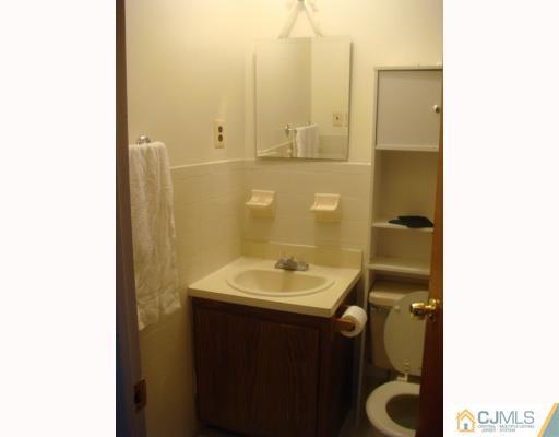 1630 Raspberry Court Edison, NJ 08817 - Photo 6 of 8 a bathroom with a sink and a mirror