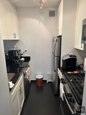 a kitchen with a sink appliances and cabinets