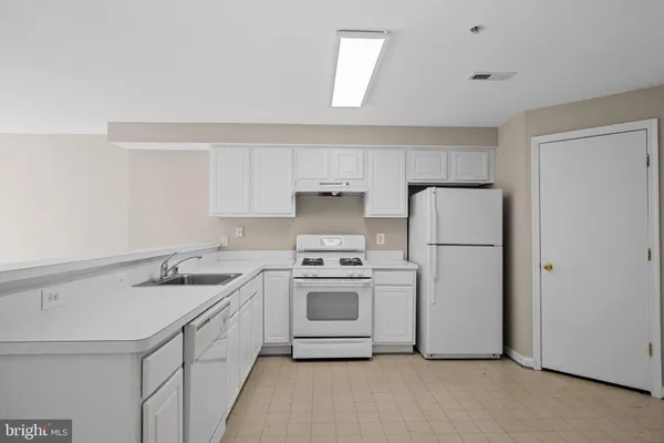 a kitchen with a sink stove and refrigerator