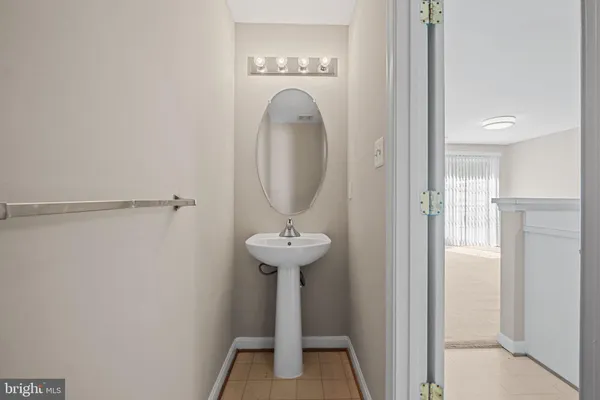 a view of a bathroom with a sink and a mirror