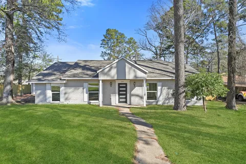 a front view of house with a garden