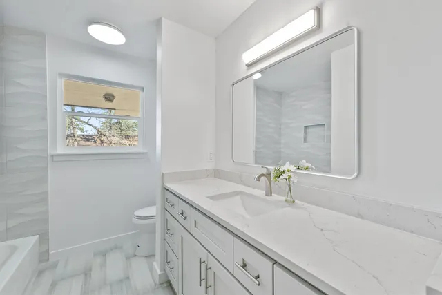 a bathroom with a bathtub and window