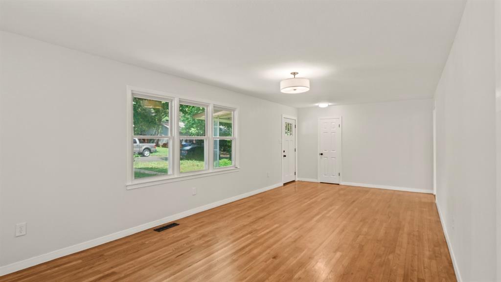 4600 Robinwood Drive Waco, TX 76708 - Photo 3 of 24 a view of empty room with wooden floor and fan