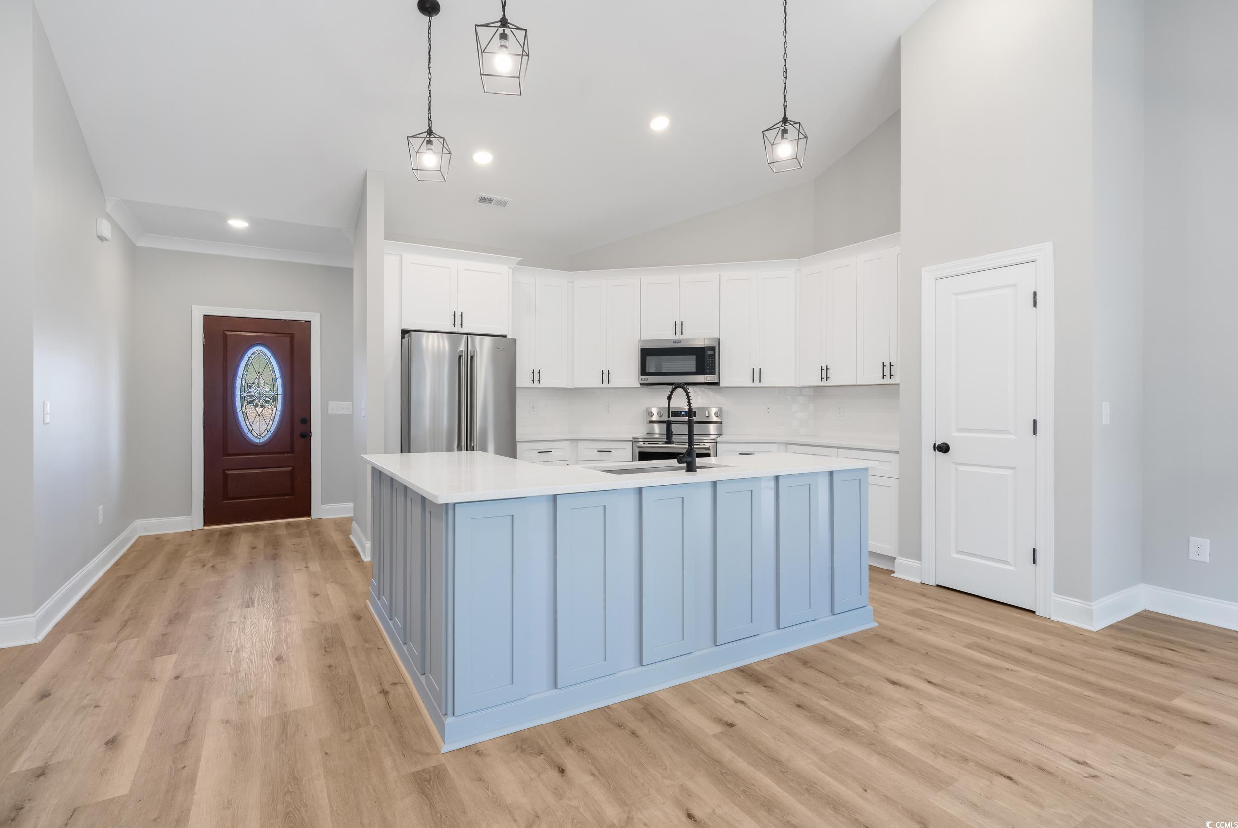 6174 Highway 66 Loris, SC 29569 - Photo 15 of 39 Kitchen with a center island with sink, white cabi