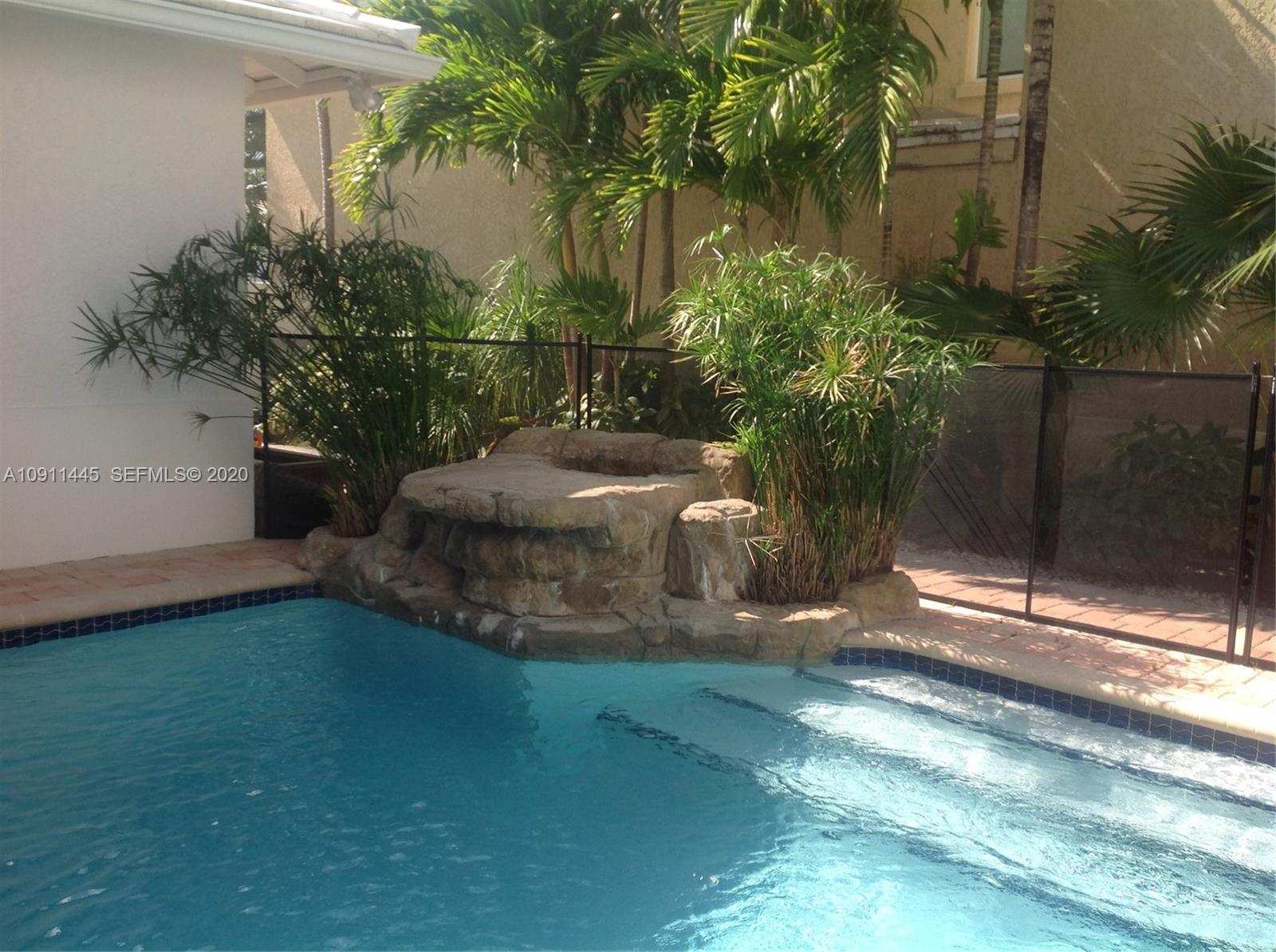 4 Turtle Walk, Unit 4 Key Biscayne, FL 33149 - Photo 11 of 54 a view of a back yard of the house
