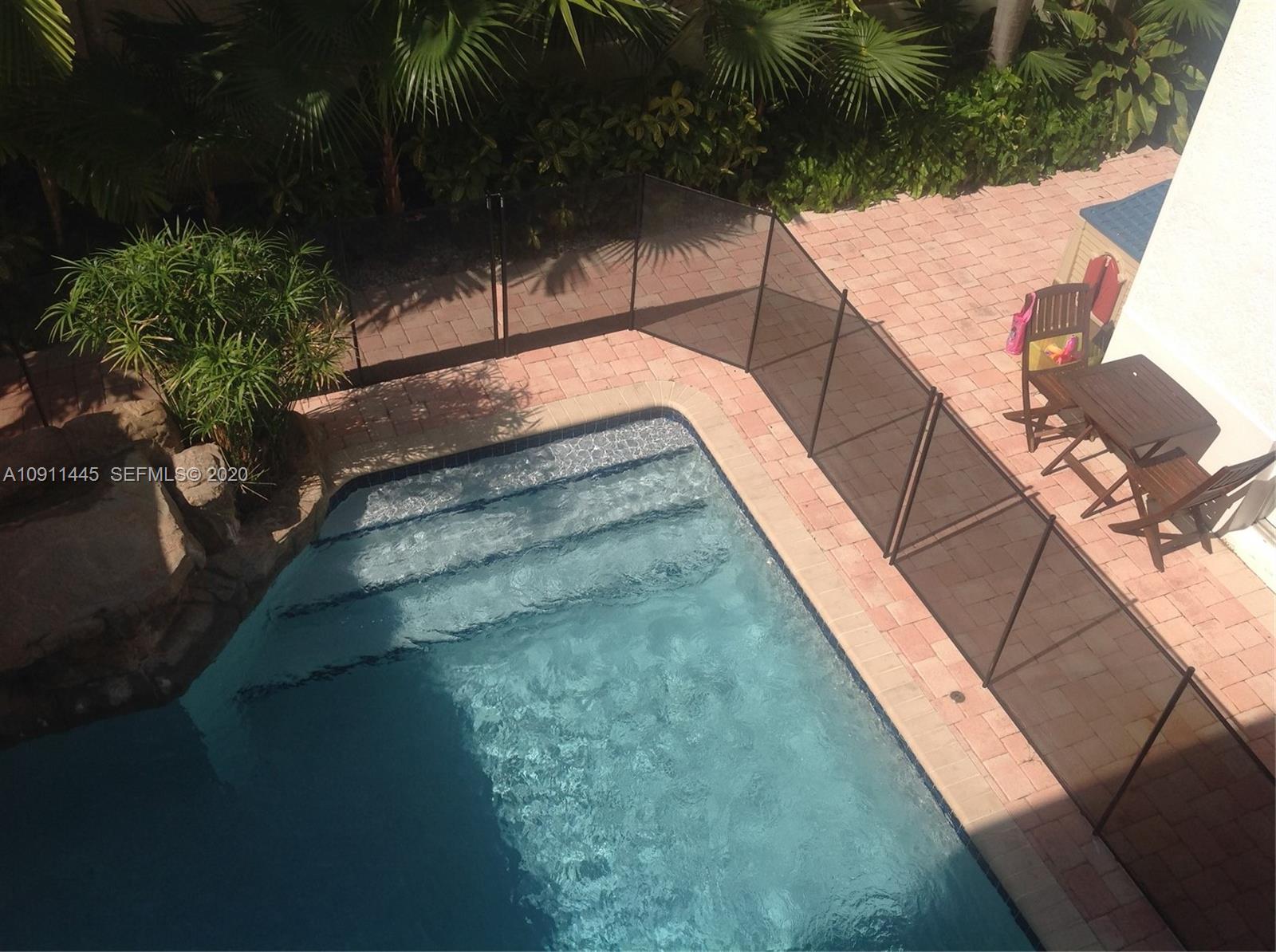 4 Turtle Walk, Unit 4 Key Biscayne, FL 33149 - Photo 13 of 54 a view of a balcony with an outdoor space