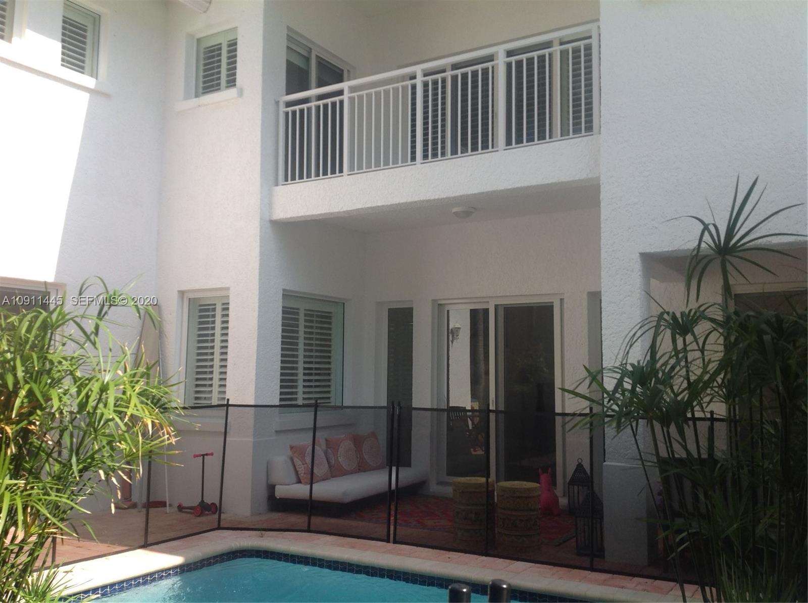 4 Turtle Walk, Unit 4 Key Biscayne, FL 33149 - Photo 19 of 54 a house view with a garden space