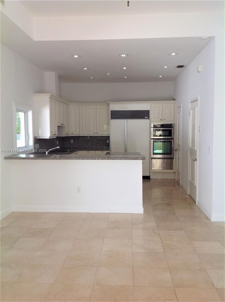 4 Turtle Walk, Unit 4 Key Biscayne, FL 33149 - Photo 20 of 54 a large kitchen with stainless steel appliances a refrigerator and a stove top oven
