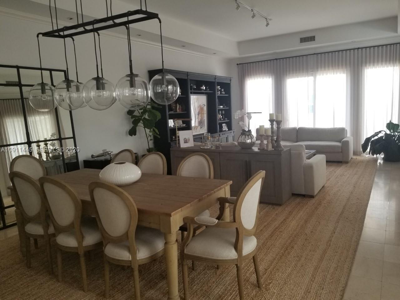 4 Turtle Walk, Unit 4 Key Biscayne, FL 33149 - Photo 2 of 54 a dining room with furniture and wooden floor