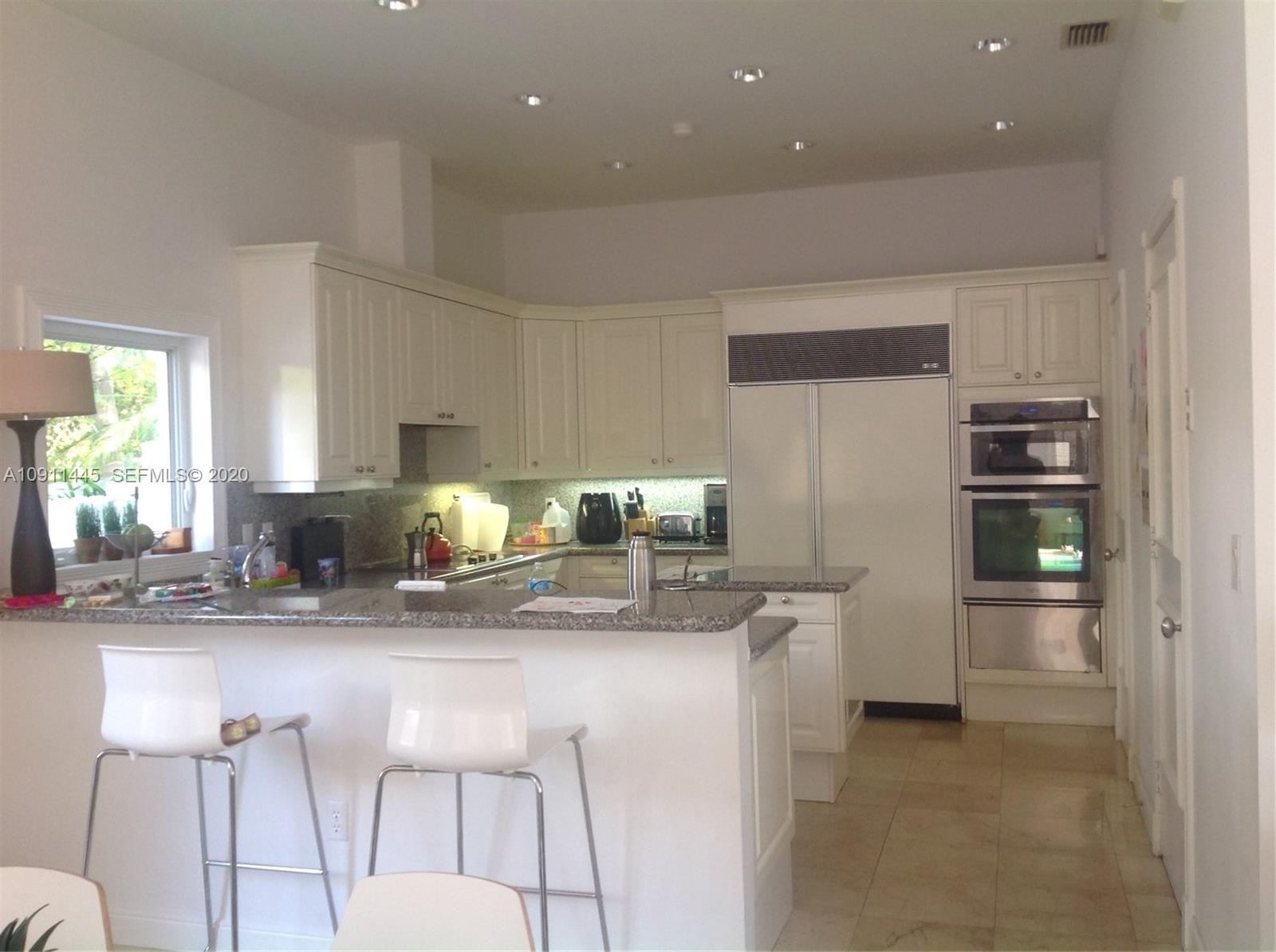 4 Turtle Walk, Unit 4 Key Biscayne, FL 33149 - Photo 21 of 54 a kitchen with stainless steel appliances granite countertop a refrigerator and a stove top oven