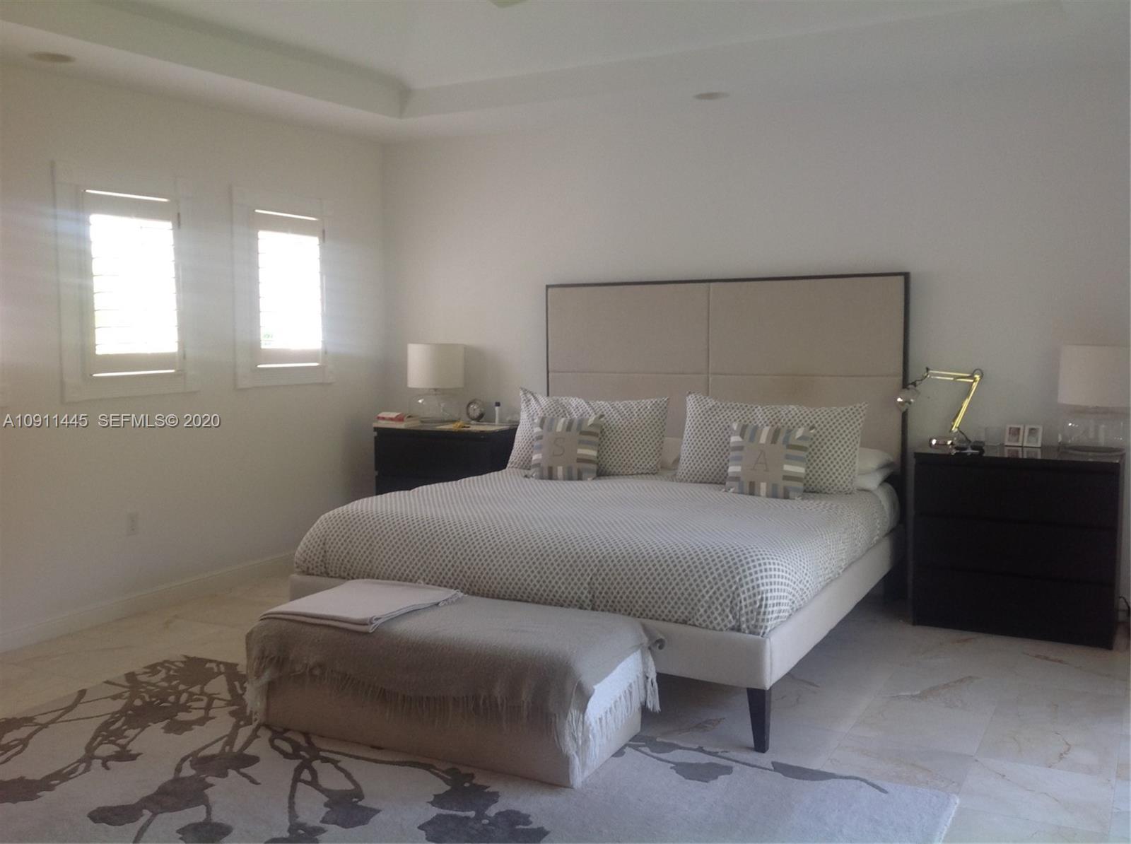4 Turtle Walk, Unit 4 Key Biscayne, FL 33149 - Photo 24 of 54 a bedroom with a bed and window