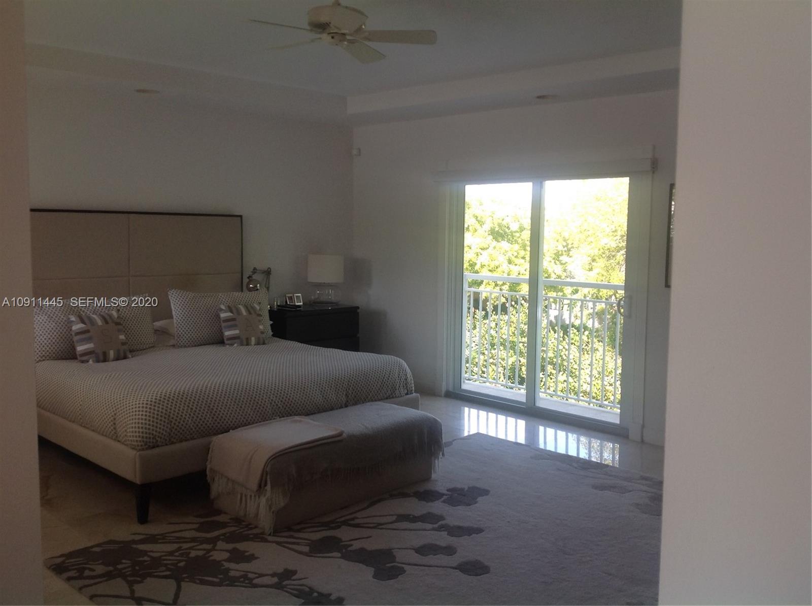 4 Turtle Walk, Unit 4 Key Biscayne, FL 33149 - Photo 25 of 54 a bedroom with a bed couch and window
