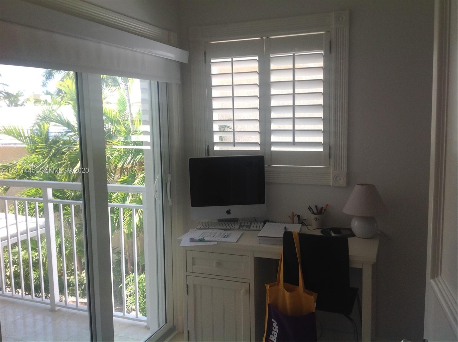 4 Turtle Walk, Unit 4 Key Biscayne, FL 33149 - Photo 26 of 54 a bathroom with a sink and a window