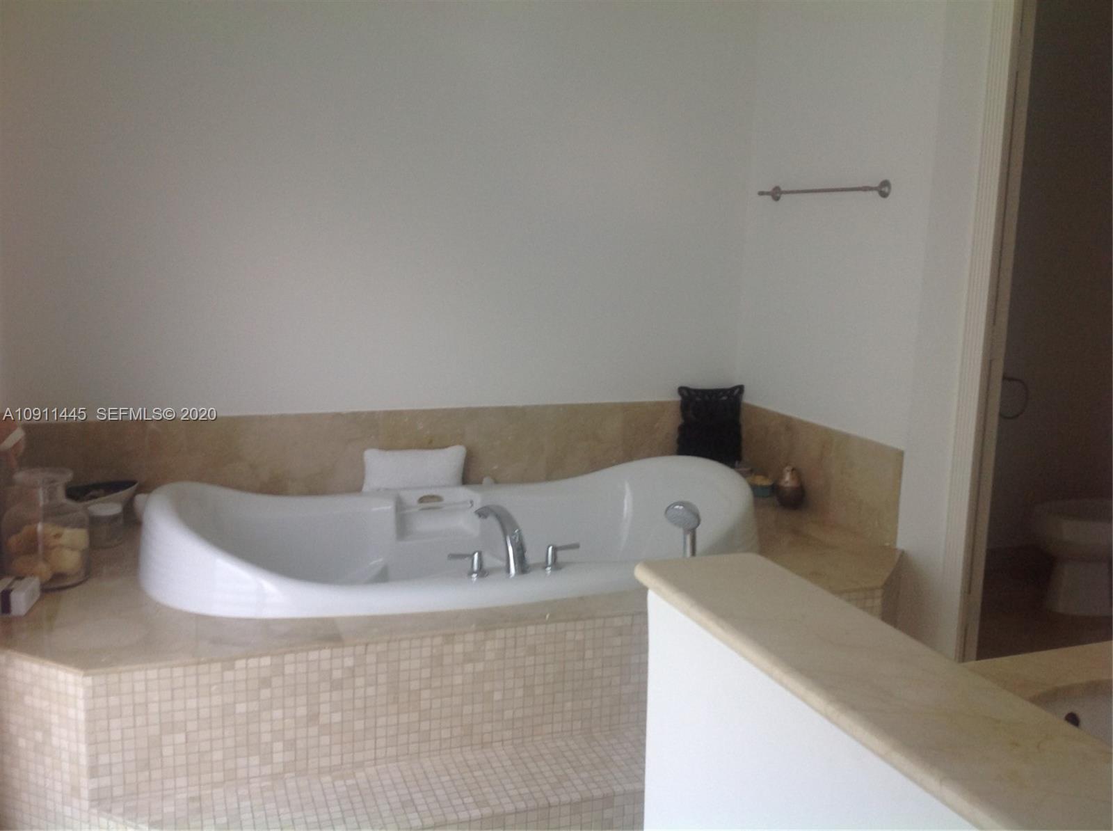 4 Turtle Walk, Unit 4 Key Biscayne, FL 33149 - Photo 28 of 54 a bathroom with a bathtub