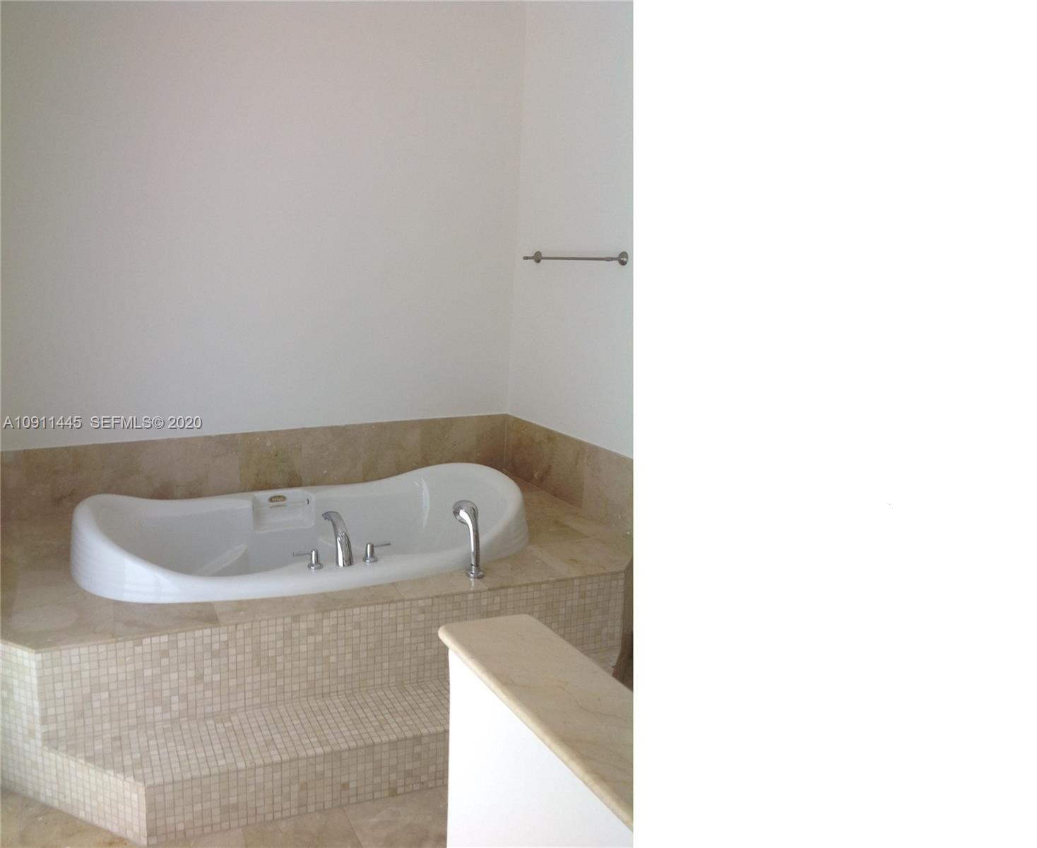 4 Turtle Walk, Unit 4 Key Biscayne, FL 33149 - Photo 29 of 54 a close up of a bathtub in a bathroom