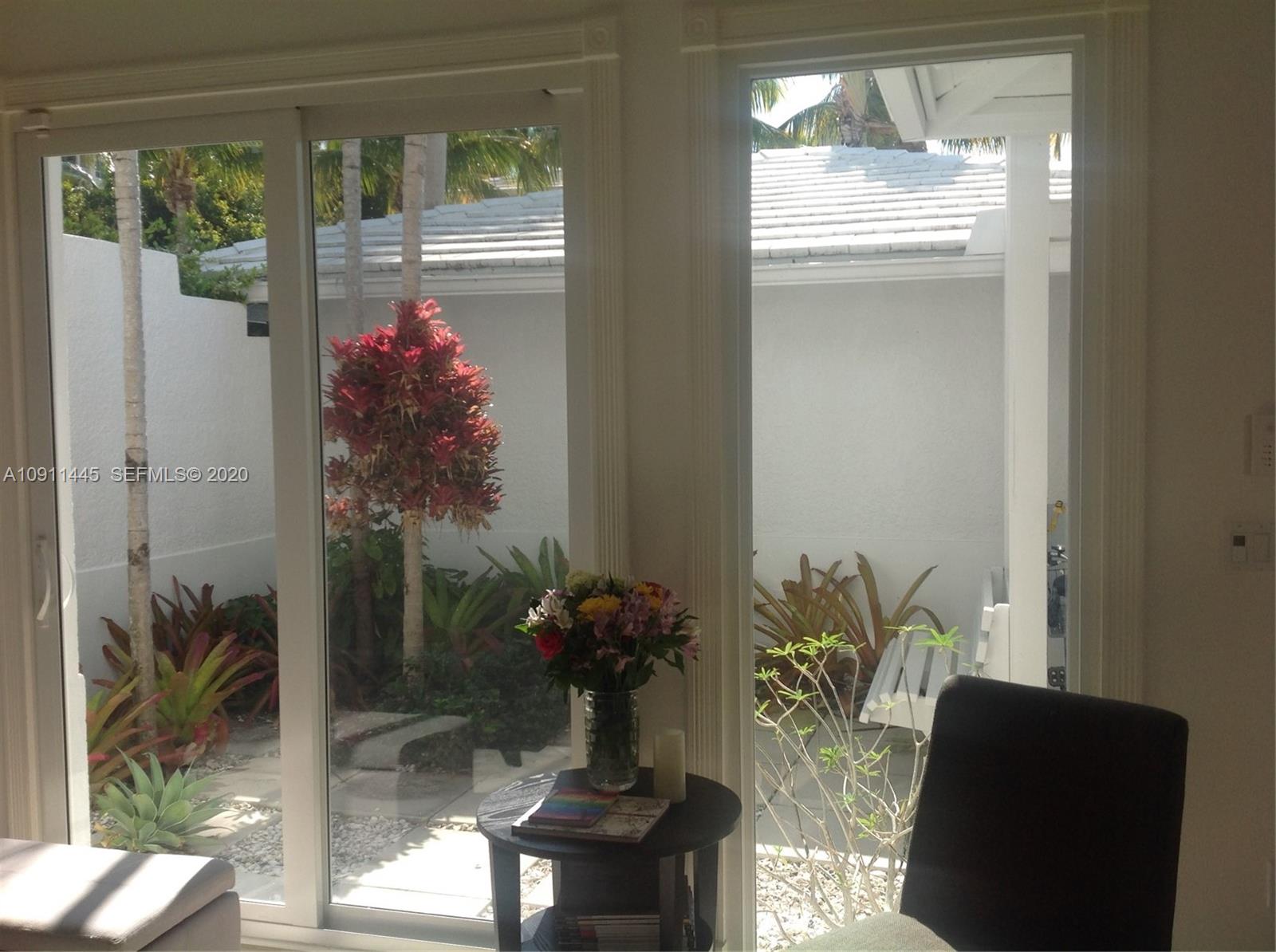 4 Turtle Walk, Unit 4 Key Biscayne, FL 33149 - Photo 3 of 54 a living room with furniture and a potted plant