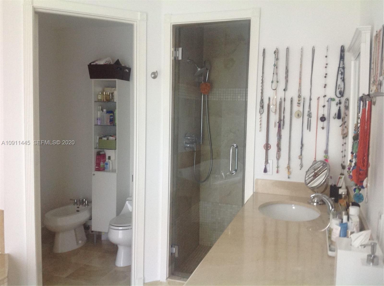 4 Turtle Walk, Unit 4 Key Biscayne, FL 33149 - Photo 31 of 54 a bathroom with a toilet and a shower