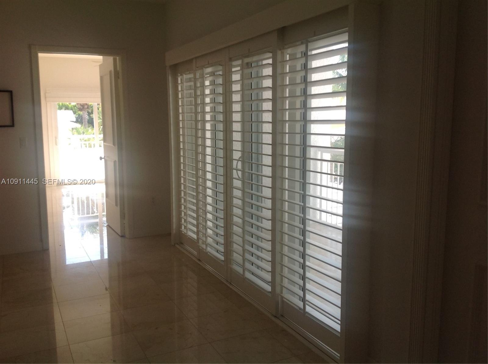 4 Turtle Walk, Unit 4 Key Biscayne, FL 33149 - Photo 35 of 54 a view of wooden floor and windows in a room