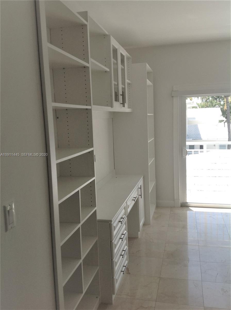4 Turtle Walk, Unit 4 Key Biscayne, FL 33149 - Photo 41 of 54 a room with a furniture and a window