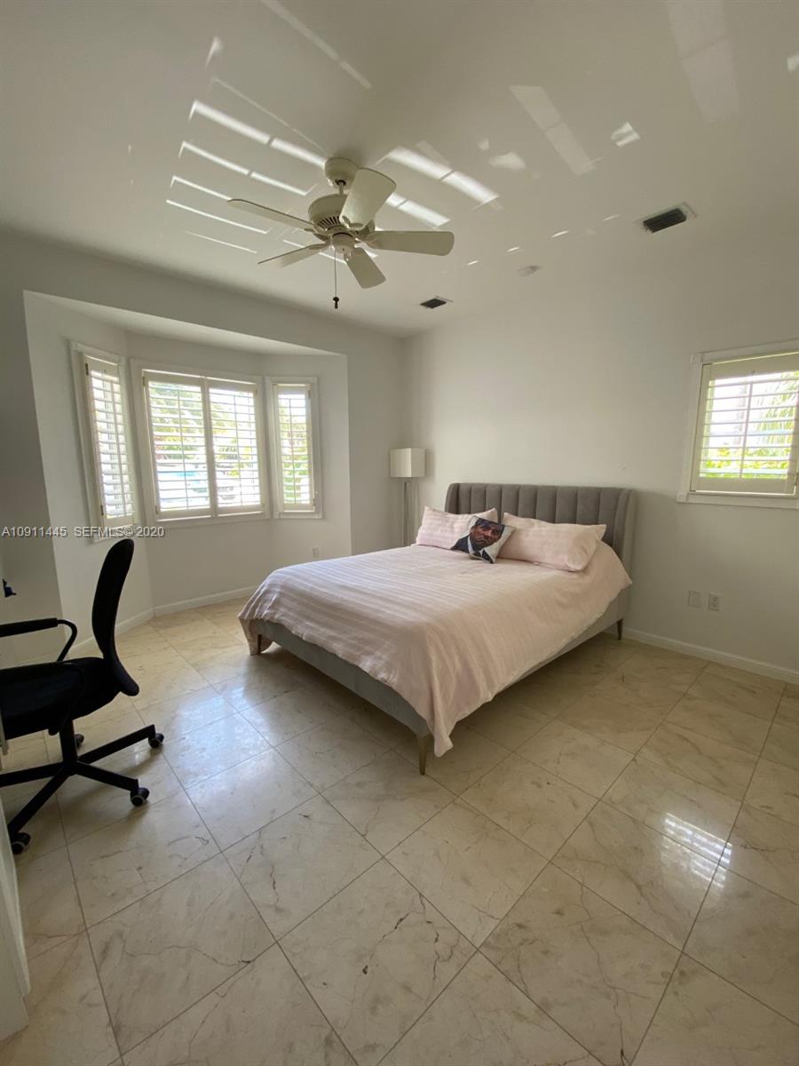 4 Turtle Walk, Unit 4 Key Biscayne, FL 33149 - Photo 43 of 54 a bedroom with a bed and window