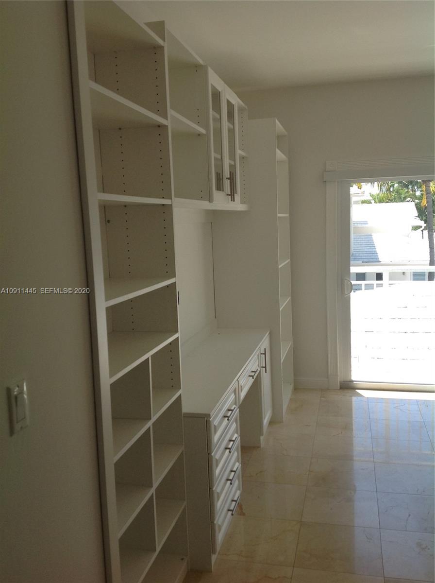4 Turtle Walk, Unit 4 Key Biscayne, FL 33149 - Photo 44 of 54 a room with walk in closet and a window