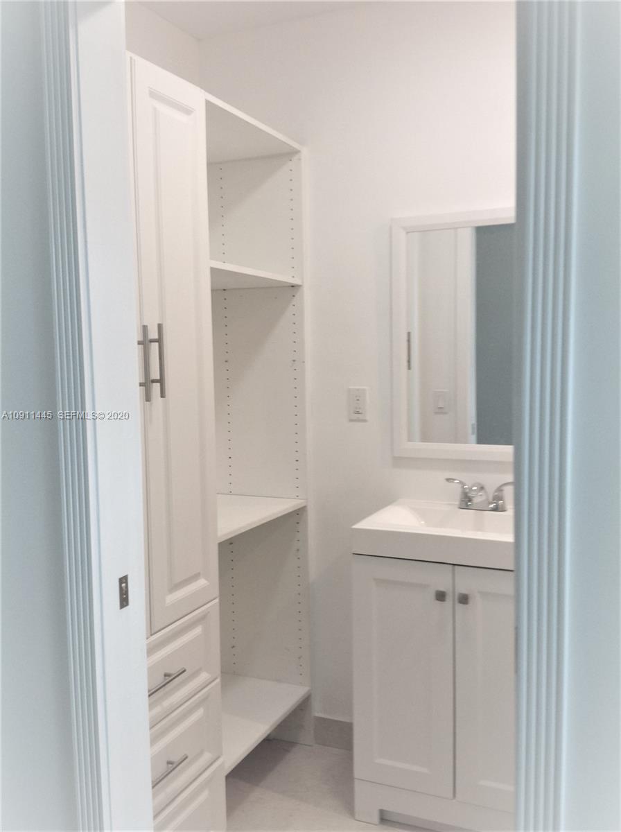 4 Turtle Walk, Unit 4 Key Biscayne, FL 33149 - Photo 50 of 54 a bathroom with a sink and mirror