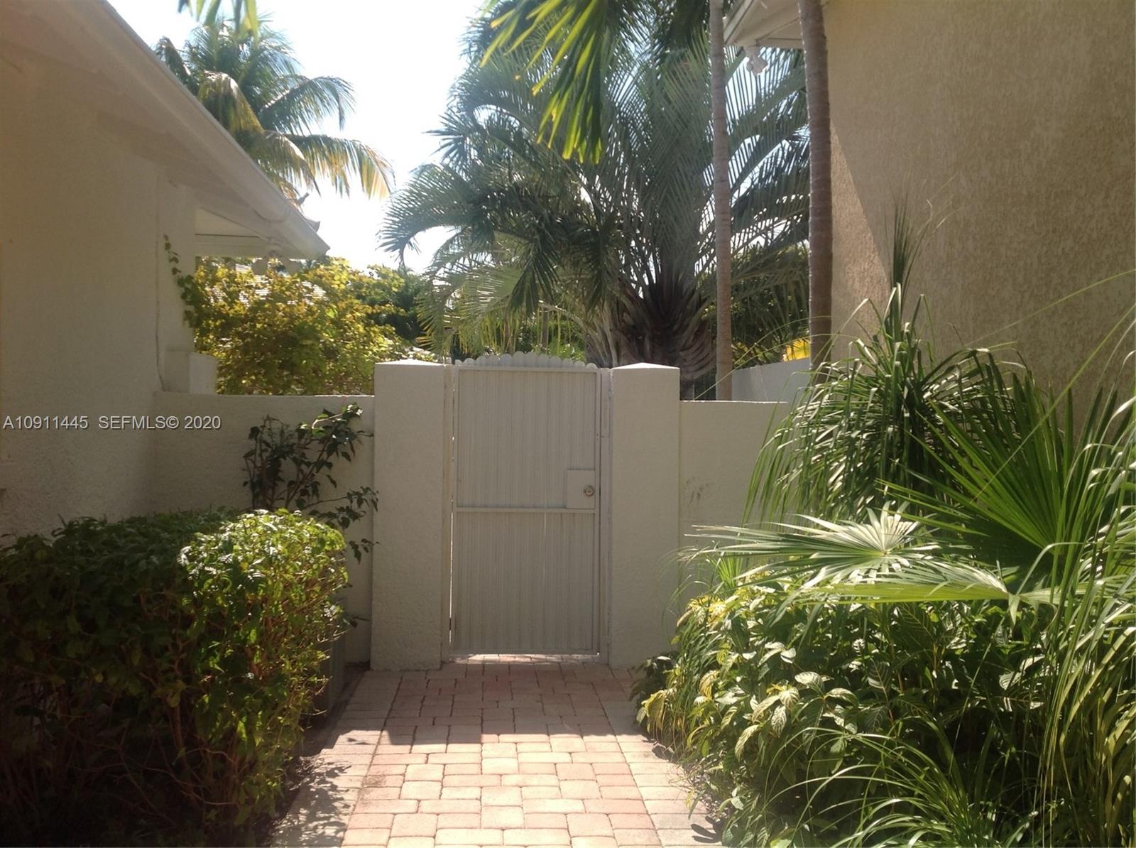 4 Turtle Walk, Unit 4 Key Biscayne, FL 33149 - Photo 53 of 54 a backyard of a house with lots of green space