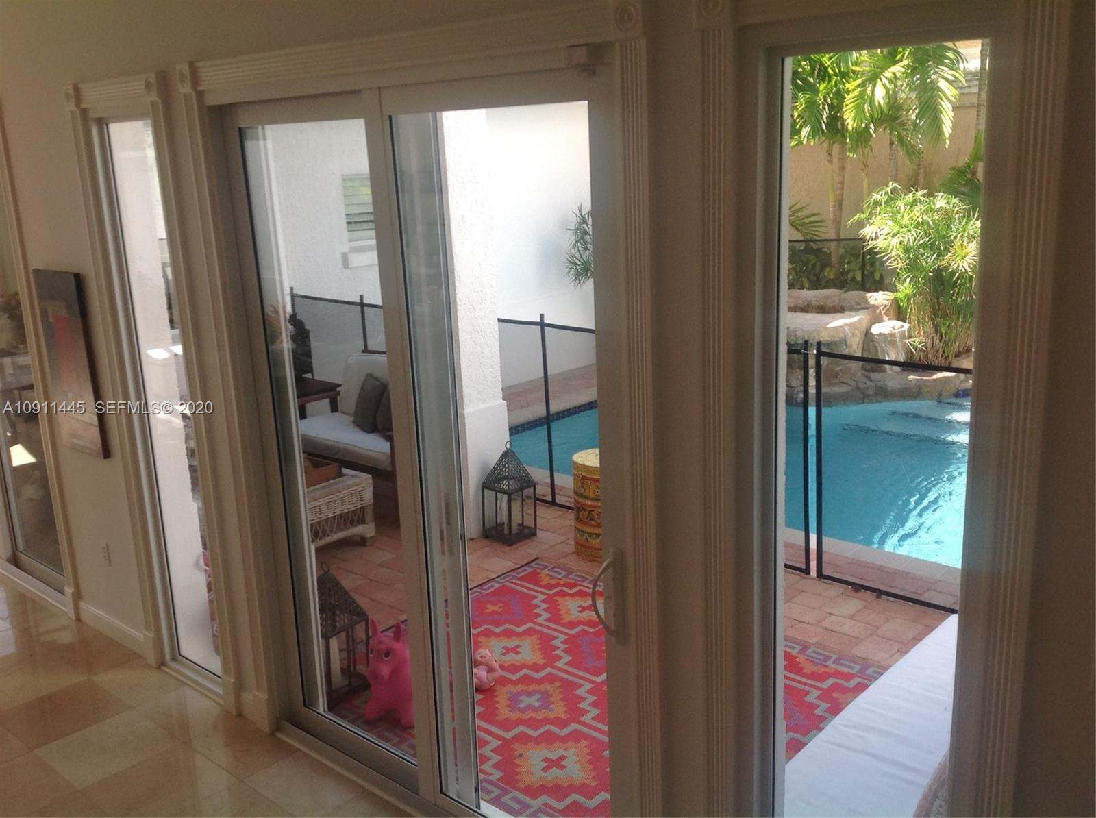 4 Turtle Walk, Unit 4 Key Biscayne, FL 33149 - Photo 7 of 54 a view of a balcony and a floor to ceiling window
