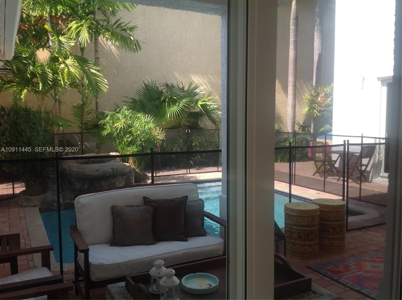 4 Turtle Walk, Unit 4 Key Biscayne, FL 33149 - Photo 8 of 54 a balcony with table and chairs