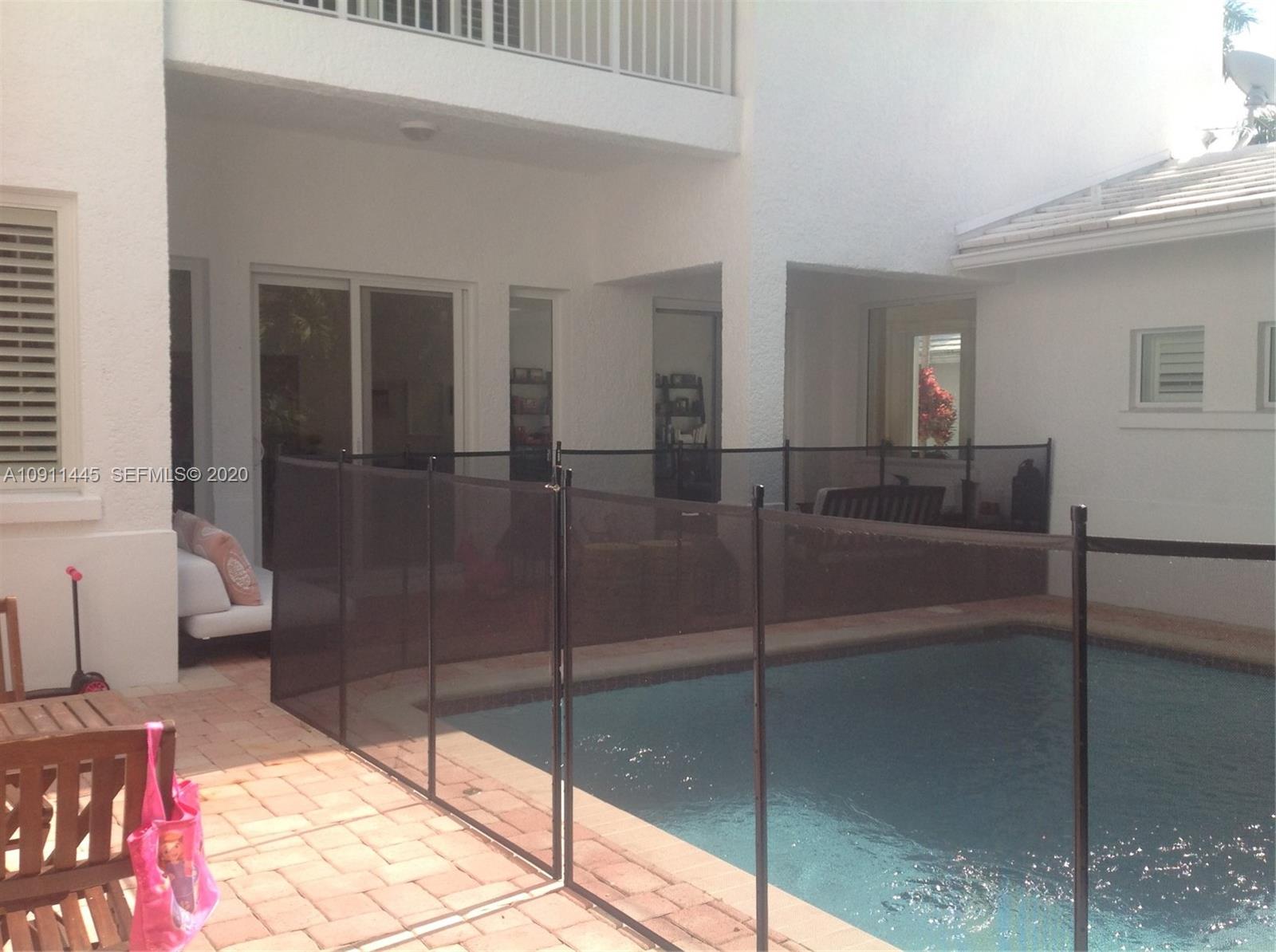 4 Turtle Walk, Unit 4 Key Biscayne, FL 33149 - Photo 9 of 54 a hallway with a glass door shower