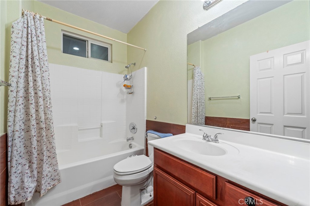 1553 West Ceres Street Rialto, CA 92376 - Photo 11 of 73 a bathroom with a sink a toilet and shower