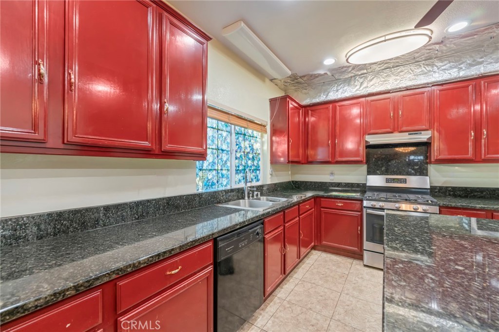 1553 West Ceres Street Rialto, CA 92376 - Photo 19 of 73 a kitchen with stainless steel appliances granite countertop wooden cabinets a sink and dishwasher