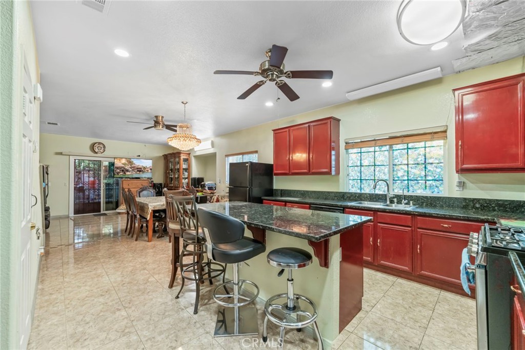 1553 West Ceres Street Rialto, CA 92376 - Photo 21 of 73 a dinning area with stainless steel appliances granite countertop a sink and a refrigerator
