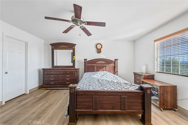 a bedroom with a large bed and a chandelier