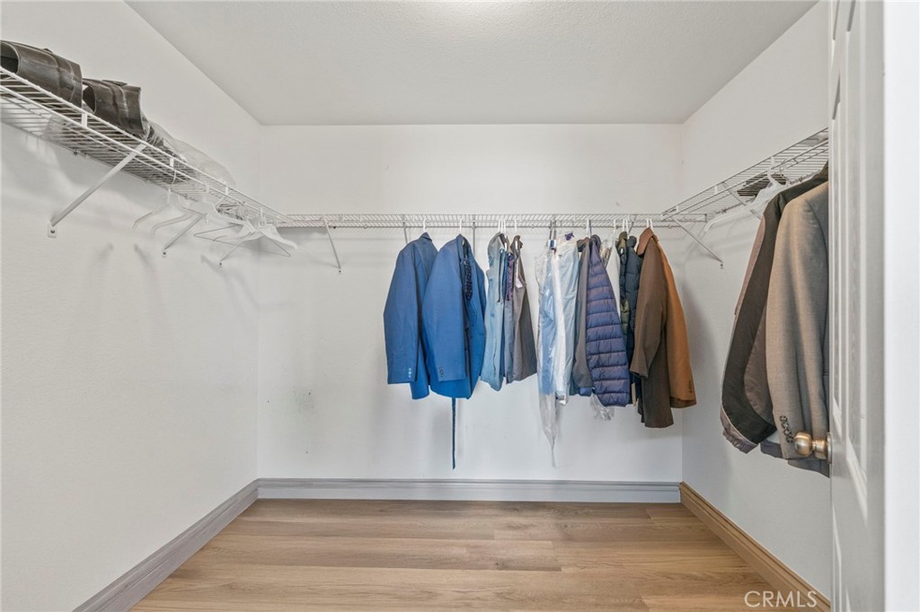 1553 West Ceres Street Rialto, CA 92376 - Photo 27 of 73 a view of walk in closet with clothes