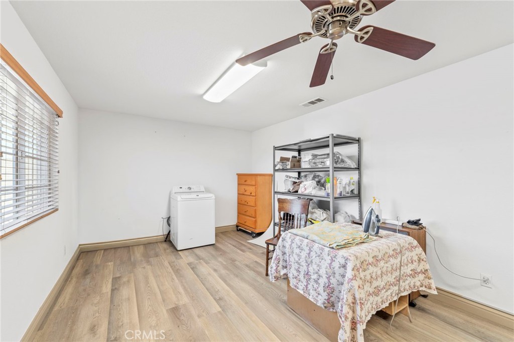 1553 West Ceres Street Rialto, CA 92376 - Photo 30 of 73 a bedroom with a bed and a chandelier