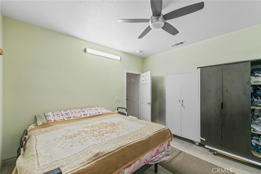 1553 West Ceres Street Rialto, CA 92376 - Photo 31 of 73 a bedroom with a bed and a dresser