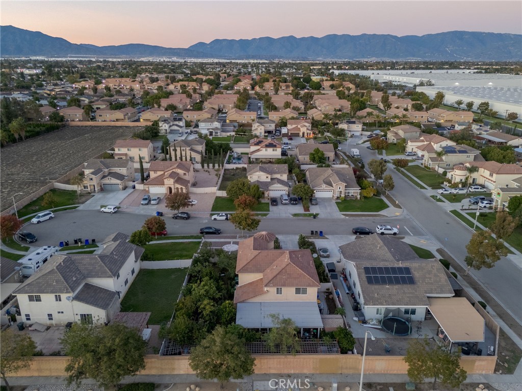 1553 West Ceres Street Rialto, CA 92376 - Photo 37 of 73 an aerial view of a city with lots of residential buildings and mountain view in back