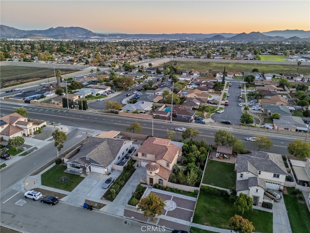 1553 West Ceres Street Rialto, CA 92376 - Photo 40 of 73 an aerial view of a city with lots of residential buildings and mountain view in back