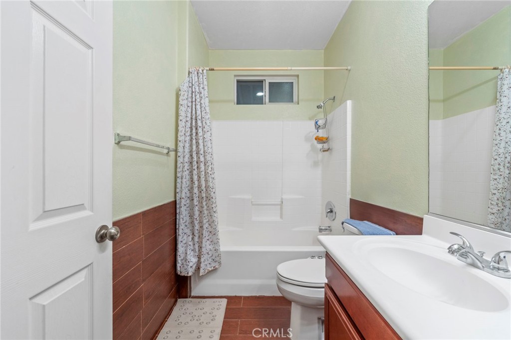 1553 West Ceres Street Rialto, CA 92376 - Photo 64 of 73 a bathroom with a sink a toilet and shower