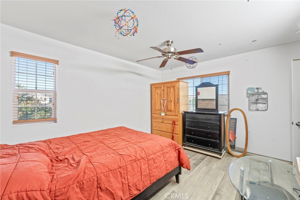 1553 West Ceres Street Rialto, CA 92376 - Photo 7 of 73 a bedroom with a large bed and a chandelier
