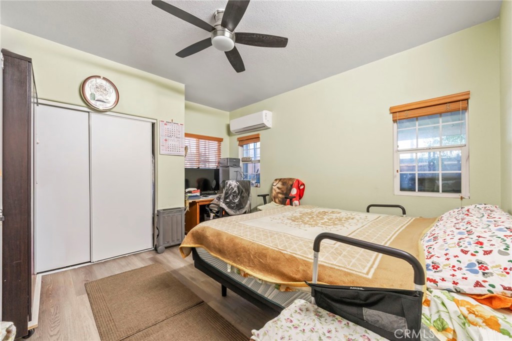 1553 West Ceres Street Rialto, CA 92376 - Photo 8 of 73 a bedroom with a bed and a chandelier