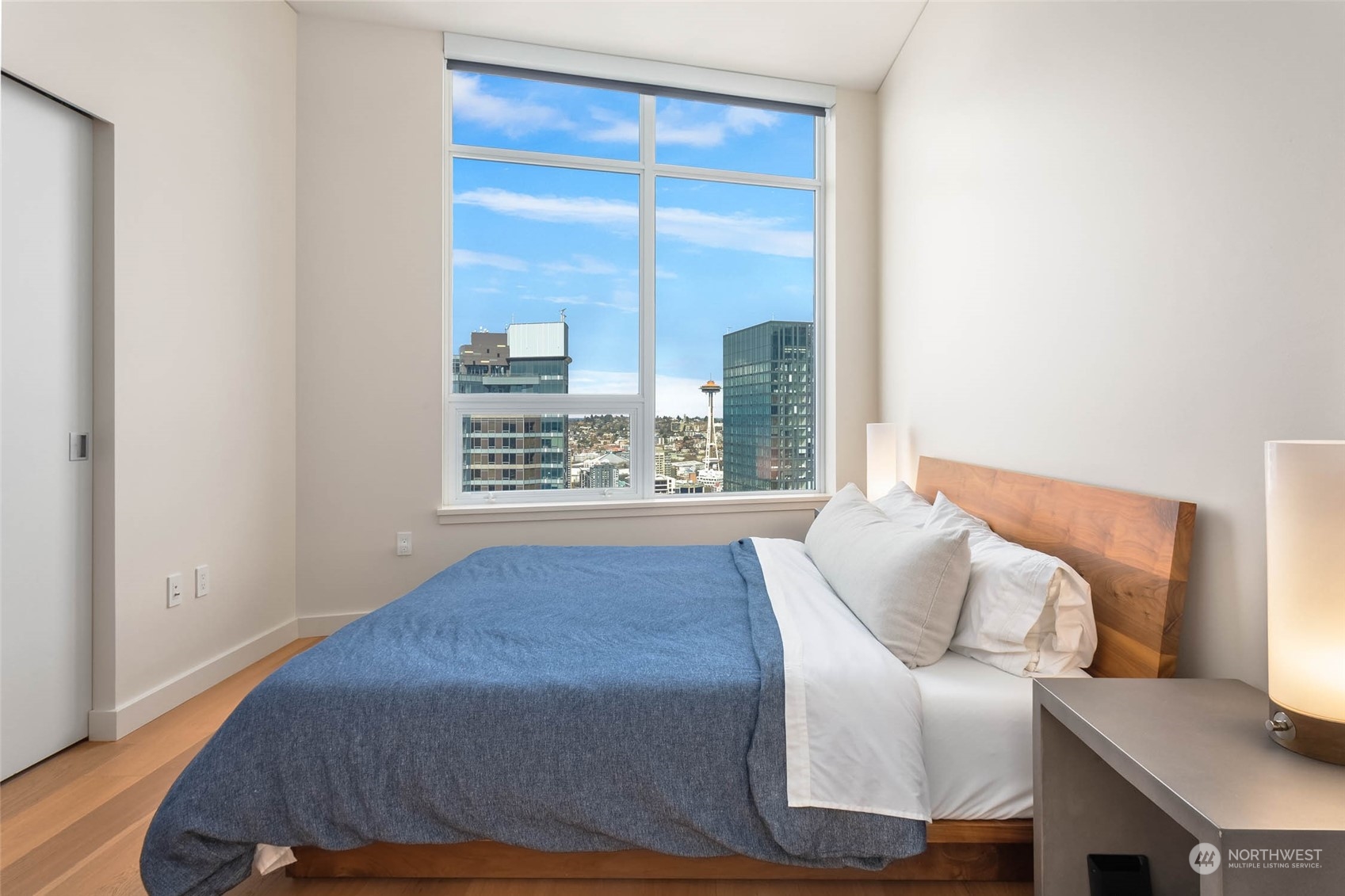 121 Stewart Street, Unit 3501 Seattle, WA 98101 - Photo 11 of 21 a view of a bedroom with furniture and a window