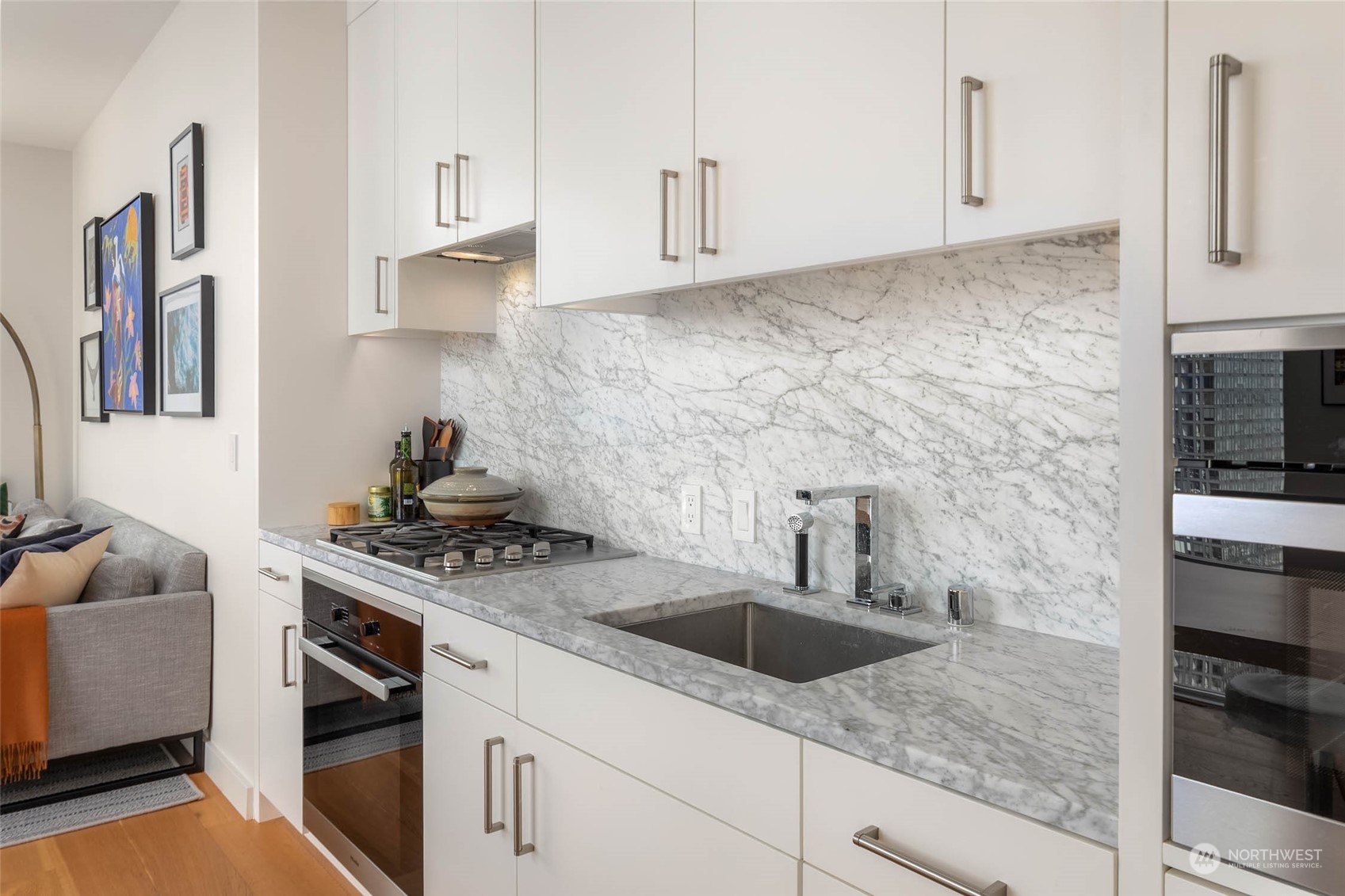 121 Stewart Street, Unit 3501 Seattle, WA 98101 - Photo 6 of 21 a kitchen with stainless steel appliances granite countertop a sink stove and cabinets