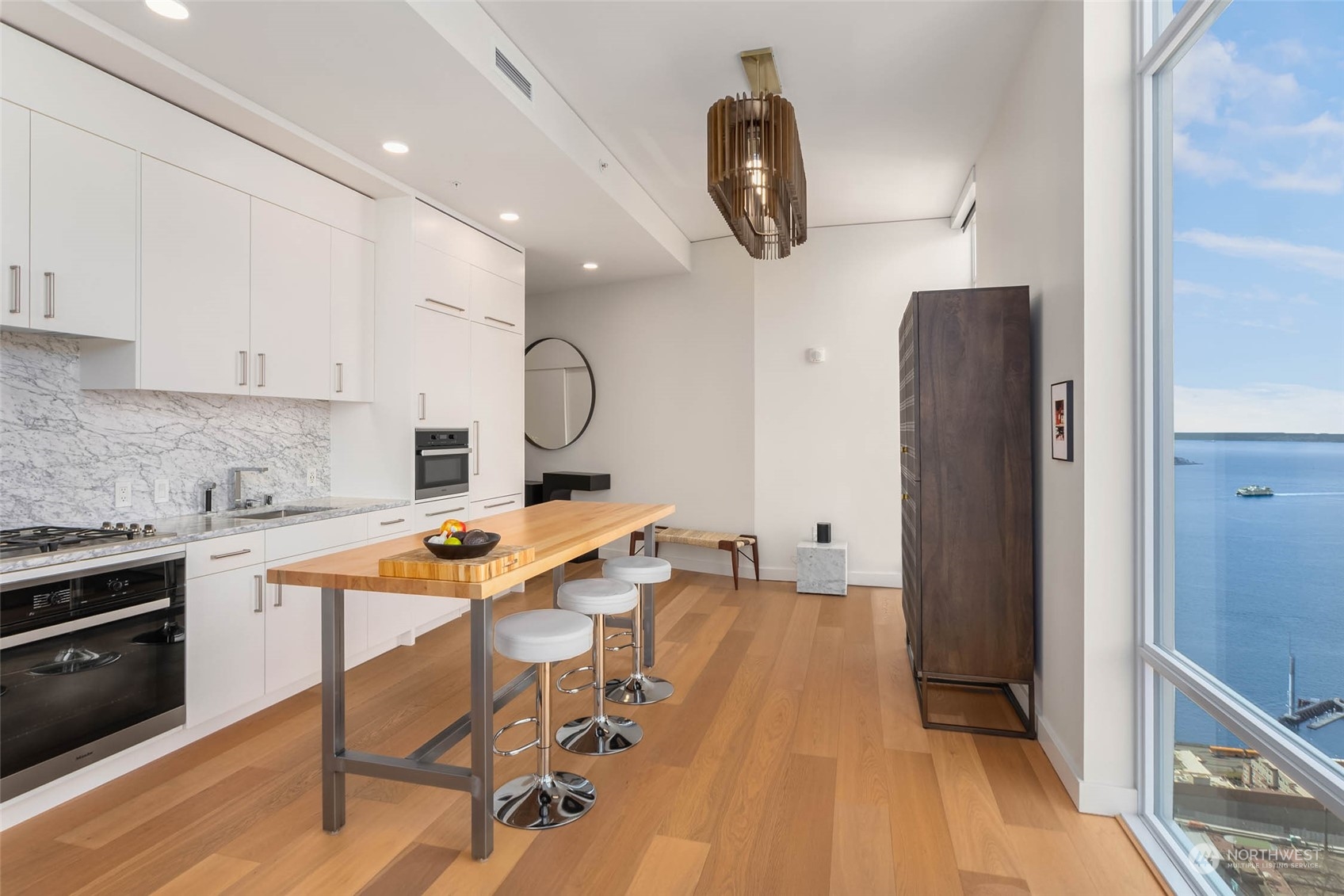 121 Stewart Street, Unit 3501 Seattle, WA 98101 - Photo 7 of 21 a room with stainless steel appliances kitchen island granite countertop furniture a refrigerator and a stove top oven