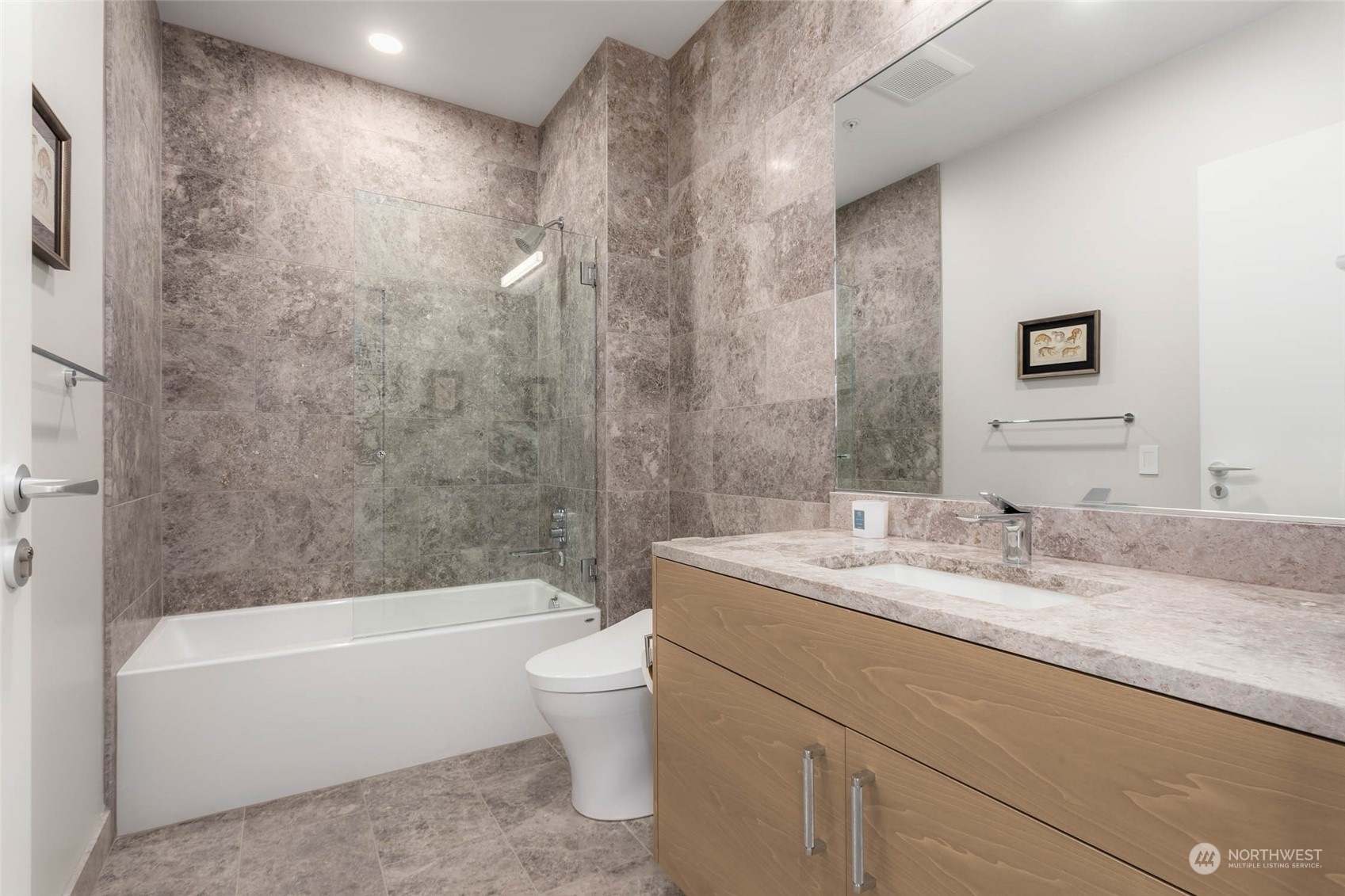 121 Stewart Street, Unit 3501 Seattle, WA 98101 - Photo 10 of 21 a bathroom with a granite countertop sink a toilet and bathtub
