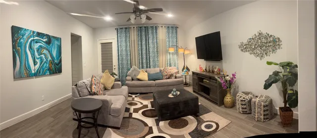 a living room with furniture and a flat screen tv