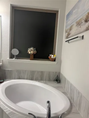 a living room with a couch and a potted plant