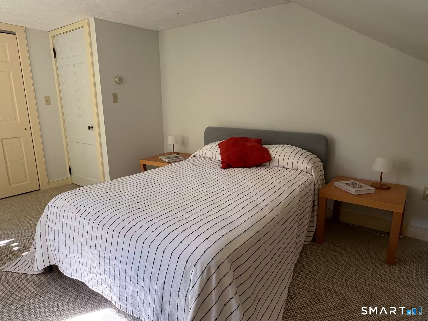 895 Tolland Stage Road Tolland, CT 06084 - Photo 16 of 33 a bedroom with a bed and a table in it